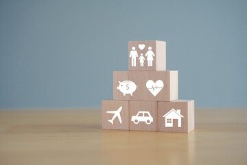 Insurance concept. Protection against a possible eventuality. House, savings, car, family, travel and health care on wooden block for Life assurance concept.