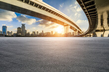 Asphalt Road Square And Bridge With City Skyline At Sunset In Shanghai
