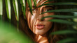 © Alina Zavhorodnii - Portrait of a beautiful girl in tropical plants with palm leaves