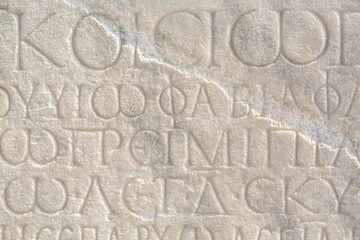 Wall Mural - Historical inscription. Fragment of ancient law (imperial edict at Ancient Greek language), carved on marble block. Ancient art and history concept. Retro text background. Kayseri, Turkey (Turkiye)