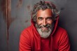 Portrait of a handsome senior man with gray beard wearing a red hoodie.