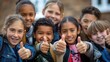 © Pro Hi-Res - Group of school kids with their thumbs up.
