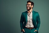 Fototapeta  - Handsome young man in a green suit and glasses. Studio shot.