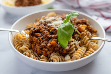 Wall Mural - Vegetarian bolognese sauce with lentils and whole wheat pasta on a plate