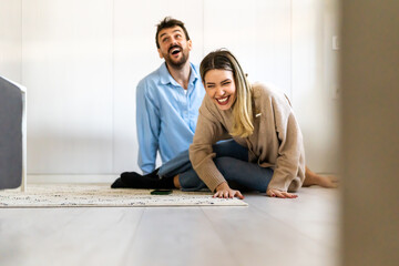 Wall Mural - A loving relationship. Beautiful couple hugging and having fun together at home.