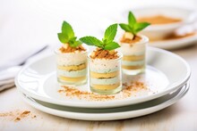 individual tiramisu cups with mint garnish