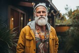 Fototapeta  - Handsome senior hipster man with long white beard and mustache wearing yellow jacket posing outdoor in the city