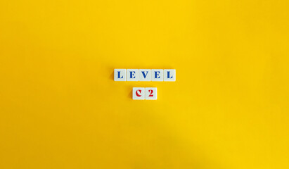 Wall Mural - level c2 word and banner. block letter tiles on yellow background. minimalist aesthetic.