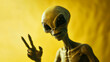© Paula - We come in peace, portrait of an alien making a peace sign on yellow background