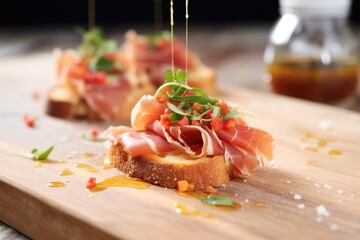 Wall Mural - bruschetta with prosciutto on top, drizzle of honey, close shot