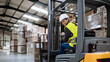 © Halfpoint - Female warehouse worker driving forklift. Warehouse worker preparing products for shipmennt, delivery, checking stock in warehouse. Banner with copy space.