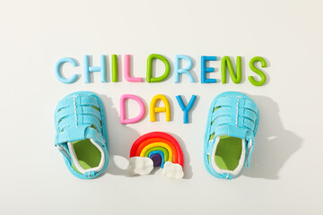 The inscription Children's Day with children's shoes