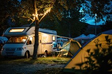 Motorhomes And Tents In The Camp At Night.