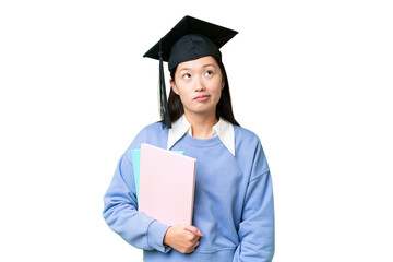 Wall Mural - Young student woman over isolated chroma key background and looking up