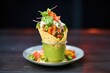 napkin-wrapped nachos cone with guacamole on top
