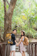 © Natee Meepian - Lovely couple lesbian woman with backpack hiking in nature. Loving LGBT romantic moment in mountains