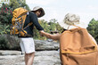 © itchaznong - Happy LGBT Lesbian couple Travelers Hiking with Backpacks in waterfall Trail. LGBT Lesbian Couple Hikers with backpacks walks in mountains in vacation