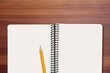 © BillionPhotos.com - Open journal with blank paper and pencil on table.