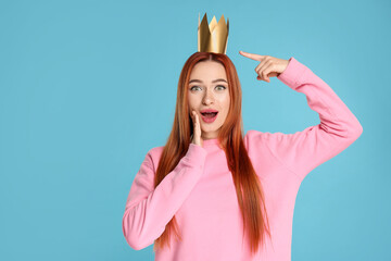 Poster - Emotional young woman with princess crown on light blue background