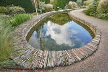 A Formal Garden Scene, With Pond, In Devon, England