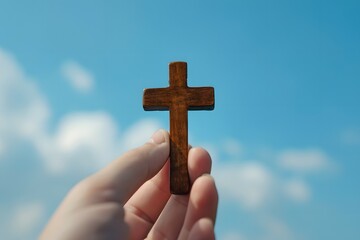 A wooden cross held against a blue sky symbolizing faith and reflection for Good Friday