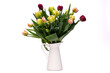 Elegant mixed tulips spring bouquet in a white vase on white background. Spring tulips. Tulips bouquet.