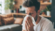 Young man sneezes, sick, home treatment