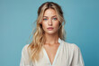 © ADDICTIVE STOCK - Beautiful woman with blond hair and blue eyes on blue background. Generative AI image