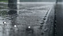Wet Road In Nature: Abstract Macro Texture Of Raindrops On Black Asphalt Surface In Winter, With A Car And Tree Leaves Reflecting The Blue And White Colors Of The Weather