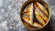 Canned fish, sprats in an open tin can, vibrant color background, minimalist