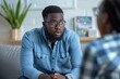 Supportive Psychologist Empathetically Listens To A Troubled Young Black Mans Concerns Standard. Сoncept Mental Health Awareness, Supportive Counseling, Empathy And Understanding