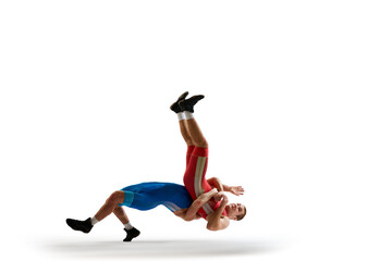 Two young man, skilled sportsman of freestyle wrestling in uniform fighting against white studio background. Concept of motion, action, combat sports, strength and power, movement,