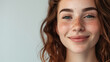 A carefree young woman with curly hair and freckles shows a playful smile is AI Generative.