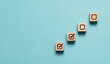 © Dilok - Correct tick mark in checkbox on wooden block cube to update work task progressive for project develop management and tracking concept.
