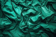 Abstract Crumpled Green Paper Texture With Shadows And Highlights Creating A Dynamic Background.