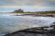 Bamburgh Castle from Harkess Rocks.  Miles of a sandy beach end at Harkess Rocks on the shoreline of the North Sea at Bamburgh in Northumberland, England