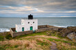 Bamburgh Lighthouse above the North Sea.  Also known as Blackrocks Point Lighthouse and part of Harkess Rocks on Bamburgh Beach on the North Sea Shoreline in Northumberland, England