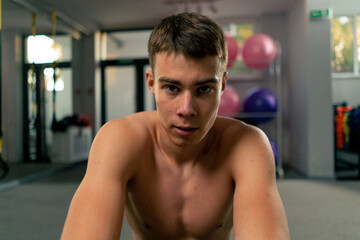 Wall Mural - portrait of a tired sweaty sportsman resting in the gym after a hard workout motivation