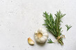 Bunch of rosemary and garlic head - traditional ingredients of mediterranean cuisine. Top view with copy space.