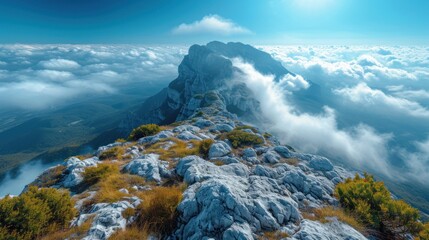 Sticker -  a view of the top of a mountain with clouds in the foreground and a bright blue sky with a few white clouds in the middle of the top of the picture.