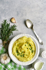 Wall Mural - Mashed potato in mediterranean style with rosemary, parmesan cheese, garlic and olive oil. Top view with copy space.