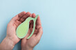 Man holding gallbladder decorative model on pastel blue background. Gallbladder disease concept, cholecystitis or biliary dyskinesia. Top view, copy space