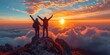 Hikers with arms raised up on mountaintop celebrating success at breathtaking sunrise