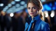 © Ilja - Professional female flight attendant in navy uniform with blurred aircraft cabin background