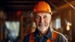 A happy elderly construction man standing on a construction site. Portrait of a caucasian male builder in an unfinished building. Guy wearing a protective hard hat in a constructing apartment building