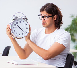 Wall Mural - Young male student sitting in the classroom