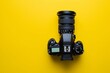 Digital single lens reflex camera from above yellow background