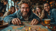 A Group Of Friends Playing Board Games At Home. Portrait Of A Young Man Wearing Glasses While Playing Board Games