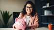 © MP Studio - Cheerful young woman, wearing glasses ,sitting at a desk with a pink piggy bank