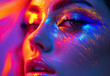 High fashion female model in colourful bright neon lights posing in studio. Close up portrait of a beautiful girl in UV. Artistic design of colourful makeup.